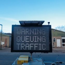 An MVIS VMS programmed using WebStudio, displaying 'Warning Queueing Traffic'.