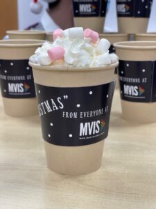 A cup of hot chocolate with a slip on for Ashgate Hospice