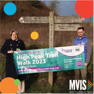 Two people stood with a banner for the ashgate hospice high peak trail