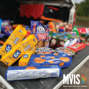 Non Perishable food items ready for a food bank, on the back of a truck.