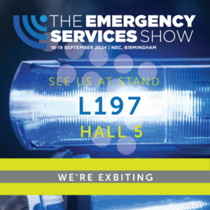 The emergency services logo on a blue blurred background of a police vehicle.