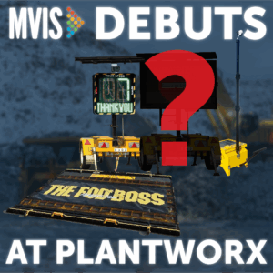 MVIS promotional graphic announcing product debuts at Plantworx. The image shows several MVIS products including a VMS (variable message sign), a solar-powered radar speed sign reading 'Your Speed Thank You,' a CCTV tower, and a platform labeled 'The Foot Boss.' A large red question mark hints at a mystery product reveal. The text reads 'MVIS Debuts at Plantworx' against a blurred construction background.